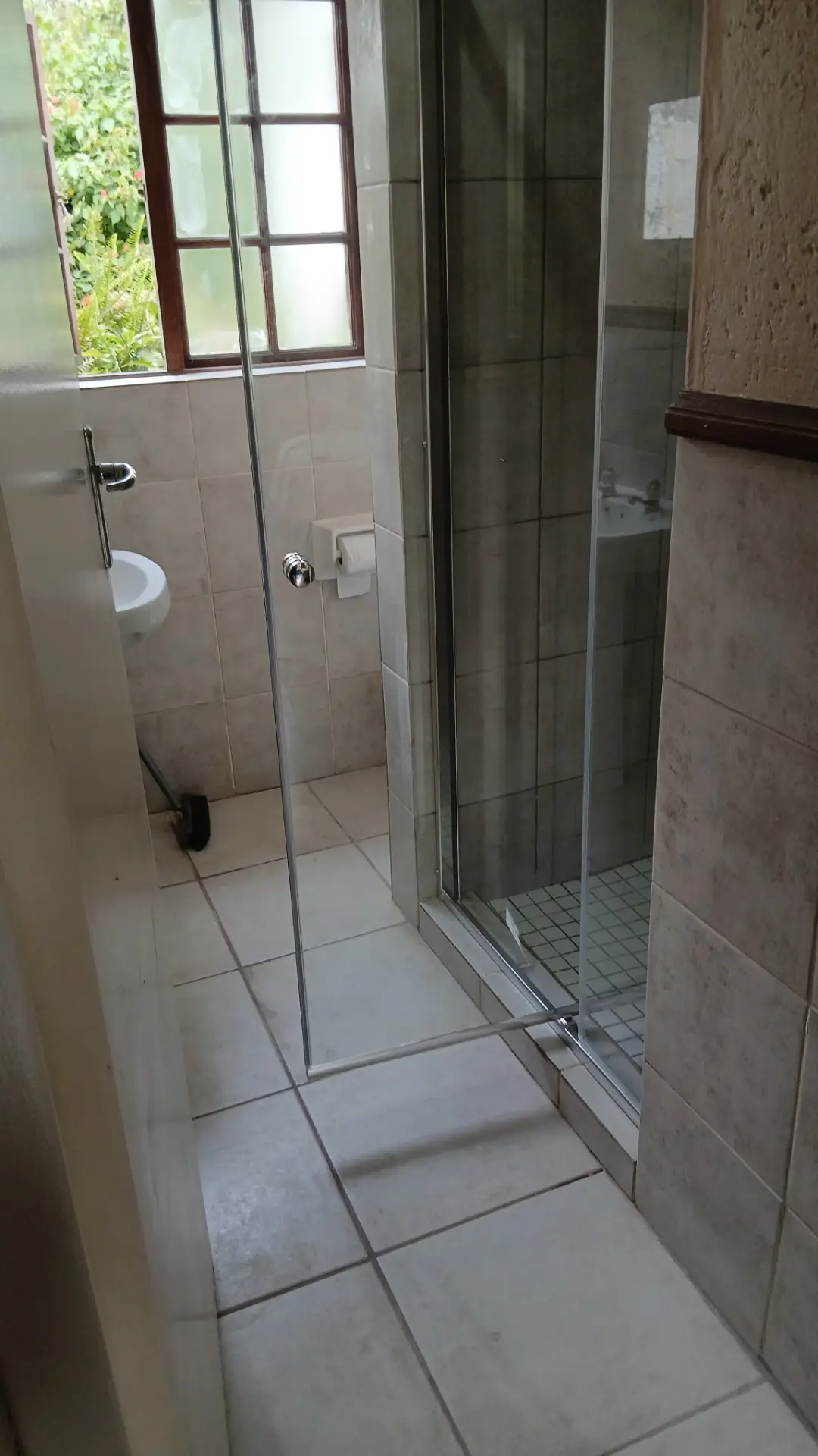 Renovated tiled bathroom with new shower enclosure