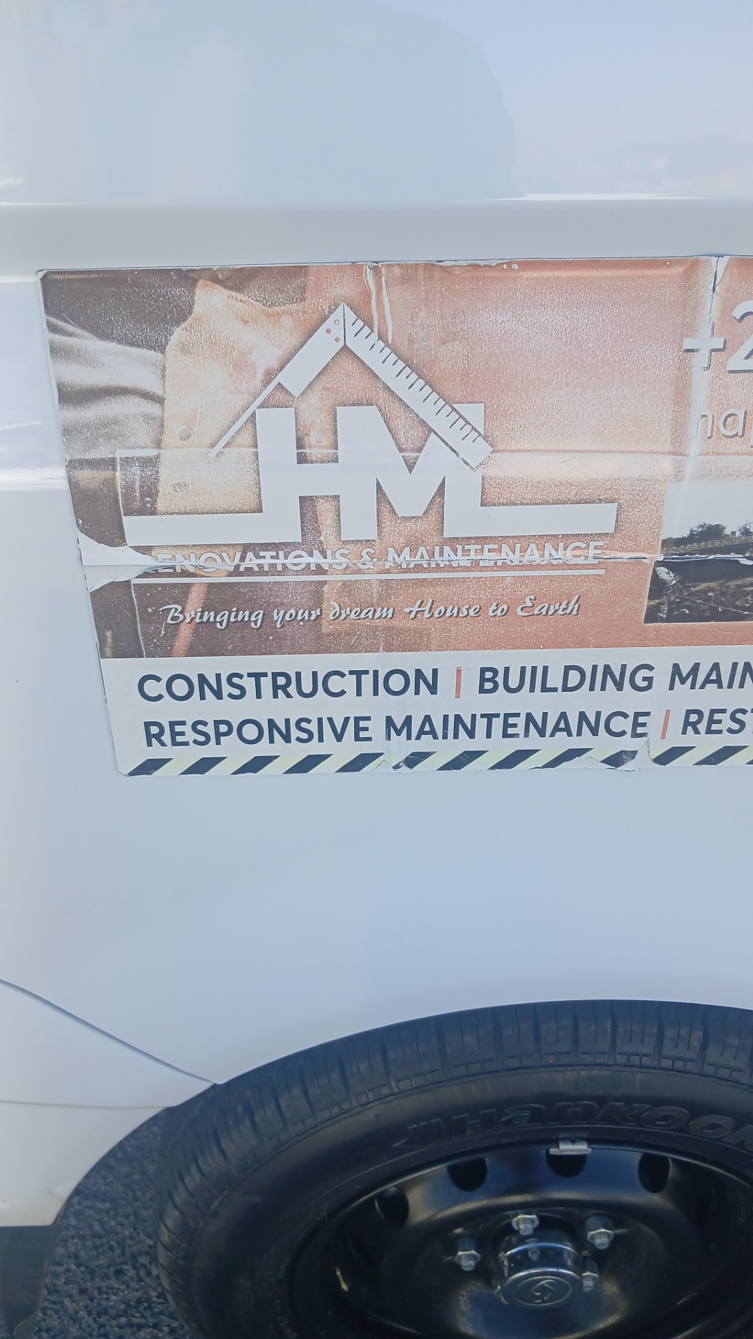 Close-up of the HM Renovations and Maintenance vehicle branding