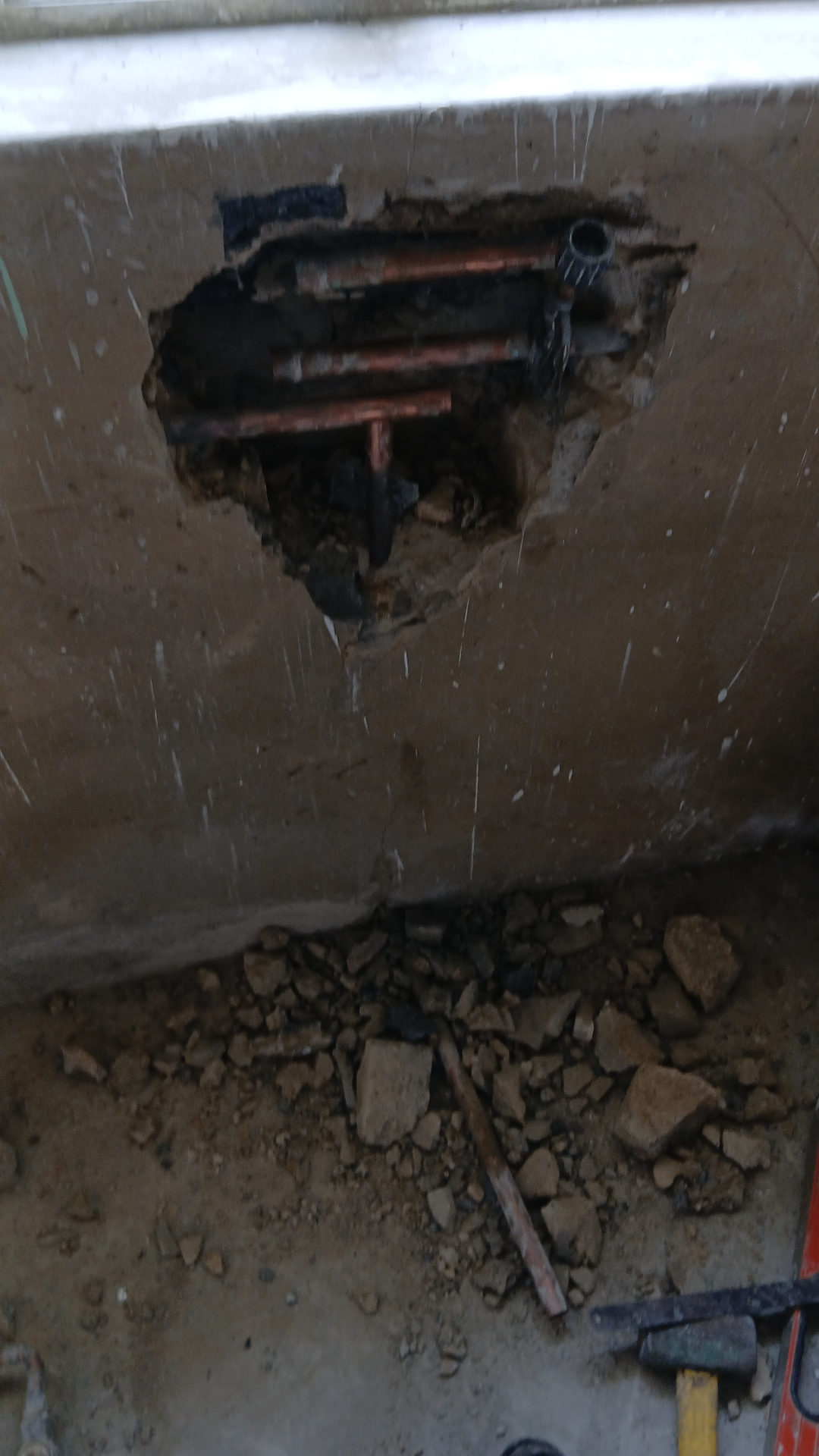 Copper water pipes exposed during a leak detection and repair job